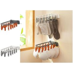 three pairs of socks hanging from hooks on the wall next to a mirror and window