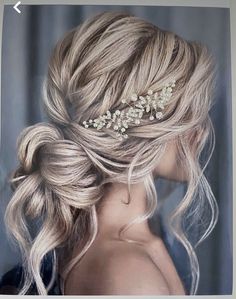 a woman with blonde hair wearing a wedding hairstyle