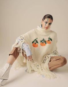 hand-knitted poncho with embroidered tangerines. Oversized. Material - 75% wool, 10% mohair, 15% acrylic Care - Dry clean only The model is: Height-174, Bust-77, Waist-54, Hips-87Measurements:XS - Bust(cm):80-82; Waist(cm):63-64; Hips(cm):87-89.S - Bust(cm):83-84; Waist(cm):65-66; Hips(cm):90-92.M - Bust(cm):88-90; Waist(cm):68-70; Hips(cm):94-96.L - Bust(cm):92-94; Waist(cm):74-76; Hips(cm):98-100.XL - Bust(cm):96-98; Waist(cm):78-80; Hips(cm):102-104. Cropped Blazer, Baby Set, Knitted Poncho, Dry Clean Only, The Model, Ponchos, Hand Knitting, Bell Sleeve Top, Dry Clean