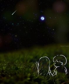 two people are sitting in the grass at night with an object in the sky above them