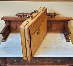 an old suitcase sitting on top of a table