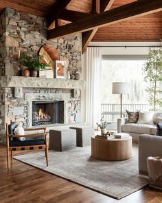 a living room filled with furniture and a fire place in the middle of a room