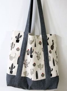 a handbag is hanging on the wall with cactus and cacti print fabric