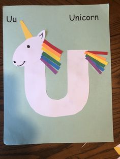 a paper cut out of the letter u with a unicorn on it