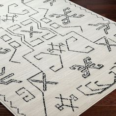 an area rug with black and white designs on it