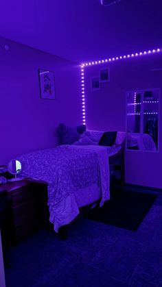 a bedroom with purple lighting and a bed