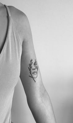 a woman's arm with a small tattoo on the left side of her body