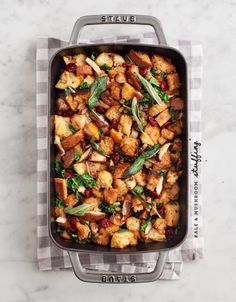 a casserole dish filled with stuffing and vegetables