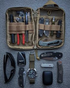 the contents of an outdoor survival kit are neatly organized