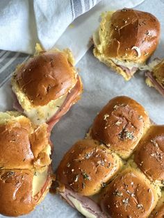 ham and cheese sliders on a white paper towel lined with napkins, ready to be eaten