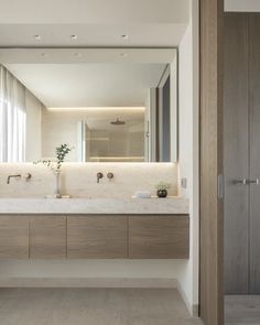 a bathroom with two sinks and a large mirror