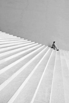 a man sitting on top of a set of stairs