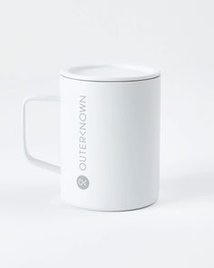 a white coffee mug with the words outer know on it's front and side