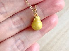 This dainty pear necklace is made of the followings: (1) gold plated green epoxy pear charm (14 x 8.5 mm) (2) gold plated or 14KGF chain and findings ✏️ Please choose the length of the chain (the length includes clasp and findings). ❣️ If you are unsure about which length to choose , please leave me a note to request an extension chain to be added to the chain at check out. 🍐EARRINGS 🍐 Hooks -> https://www.etsy.com/listing/919575709 🍐OTHER STYLE 🍐 YELLOW PEAR → https://www.etsy.com/listin Handmade Pear-shaped Gold Necklace, Handmade Pear-shaped Necklace For Gift, Handmade Pear-shaped Necklace Gift, Yellow Pendant Charm Necklace For Gift, Yellow Charm Necklace With Adjustable Chain As Gift, Yellow Teardrop Necklace For Gifts, Gold Pear-shaped Necklaces With Delicate Chain, Gold Necklace With Delicate Pear-shaped Chain, Gold Pear-shaped Necklace With Delicate Chain