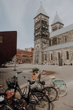 two bicycles parked next to each other in front of a church