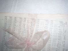 an old sheet with music notes and a bow tied to it's side,