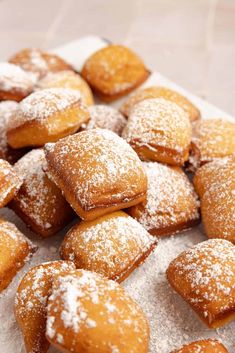 powdered sugar covered pastries on a white plate