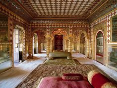 an elaborately decorated room with gold and red accents