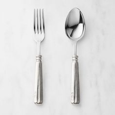 two forks and spoons sitting next to each other