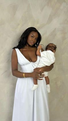 a woman holding a baby in her arms