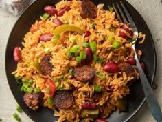 a black plate topped with rice and beans