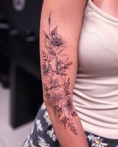 a woman with a flower tattoo on her arm