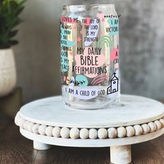 a glass jar with words on it sitting on top of a table