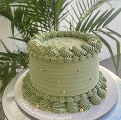 a green cake sitting on top of a white plate