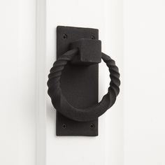 a black door handle on a white door with a rope wrapped around the front ring