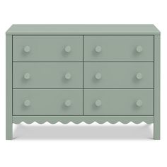 a green dresser with white dots on the top and bottom drawer, it has four drawers