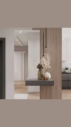 a modern kitchen with white walls and wood flooring, along with an open area for seating