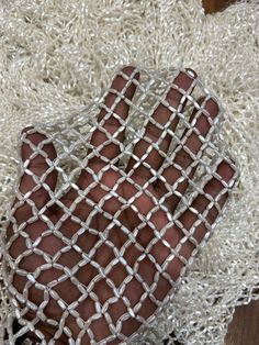 a hand that is holding something in it's palm on some kind of rug