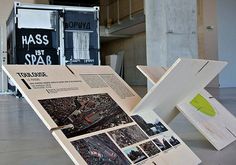 an open book sitting on top of a wooden table in front of a sign that says mass art space