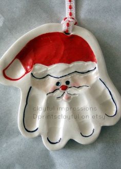 an ornament shaped like a santa claus hat on top of a white sheet