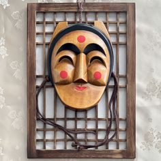 a wooden mask hanging on a wall