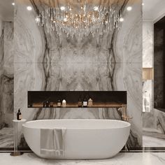 a bathroom with a large bathtub and chandelier hanging from it's ceiling