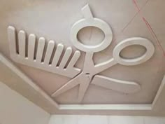 the ceiling is decorated with scissors and wire