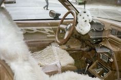 the interior of a car with sheepskin on the dashboard