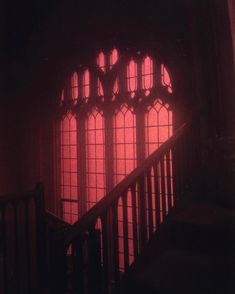 the light is shining through two windows in an old building with stairs leading up to it