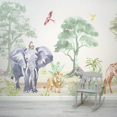 an elephant, giraffe and zebra wall mural in a children's room