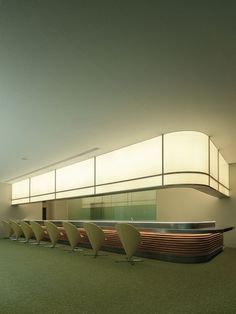 a row of chairs sitting in front of a counter