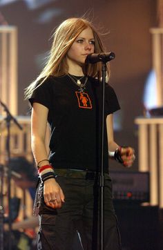 a woman standing in front of a microphone