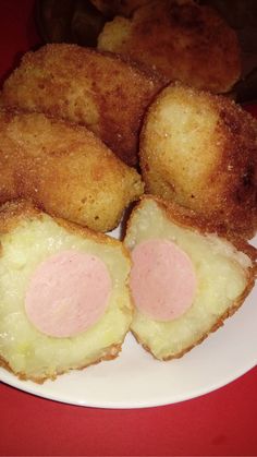 some fried food on a white plate with pink toppings and two other foods in the background