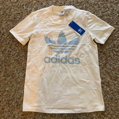 New With Tags/Color: White/Clear Sky Blue Adidas T-shirt With Logo, White Crew Neck T-shirt With Logo, Adidas White T-shirt For Streetwear, White Adidas T-shirt For Streetwear, Adidas Logo White Tops For Streetwear, White Adidas Logo Top For Streetwear, White Adidas Logo Casual Tops, White Adidas Graphic Tee, White Adidas Graphic Tee With Logo