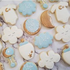 baby shower cookies are arranged on a marble surface