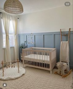 a baby's room with a crib, rocking horse and other items on the floor