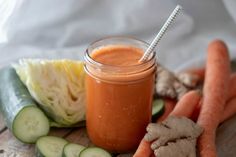 carrots, celery, and cucumbers are on a cutting board