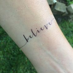 a woman's arm with the word alive written in cursive writing on it