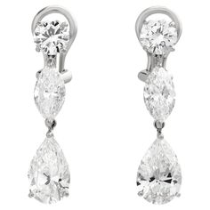 These exquisite Cartier multi-shape diamond drop earrings showcase a stunning array of meticulously selected diamonds, artfully arranged to capture light from every angle, epitomizing timeless elegance and luxury. These earrings feature: 2 round diamonds - 0.50 carat, E/VVS2; 0.56 carat, E/VVS1. Both GIA certified. 2 marquise diamonds - 0.78 carat, D/VS2; 0.80 carat, D/VVS1. Both GIA certified. 2 pear diamonds - 1.50 carat, E/VS2; 1.52 carat, E/VS2. Both GIA certified. A total of ~5.66 carats. N Luxury Cartier Earrings For Anniversary, Elegant Cartier Diamond Earrings, Luxury Cartier Fine Jewelry Earrings, Vintage Cartier Earrings, Cartier Diamond Accents Evening Jewelry, Pear Diamond, Diamond Drop Earrings, Marquise Diamond, Diamond Drops