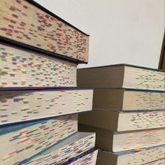 several books stacked on top of each other with colored dots all over the pages,